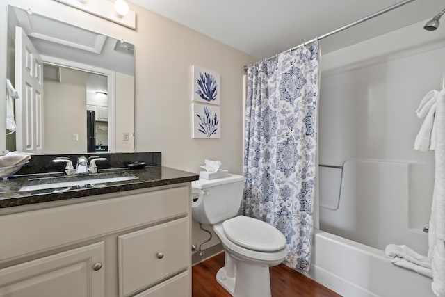 full bathroom featuring shower / bathtub combination with curtain, hardwood / wood-style floors, vanity, and toilet