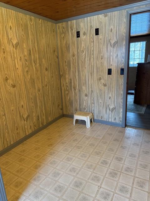 spare room featuring wooden ceiling and wood walls