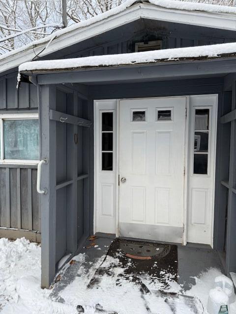 view of snow covered property entrance