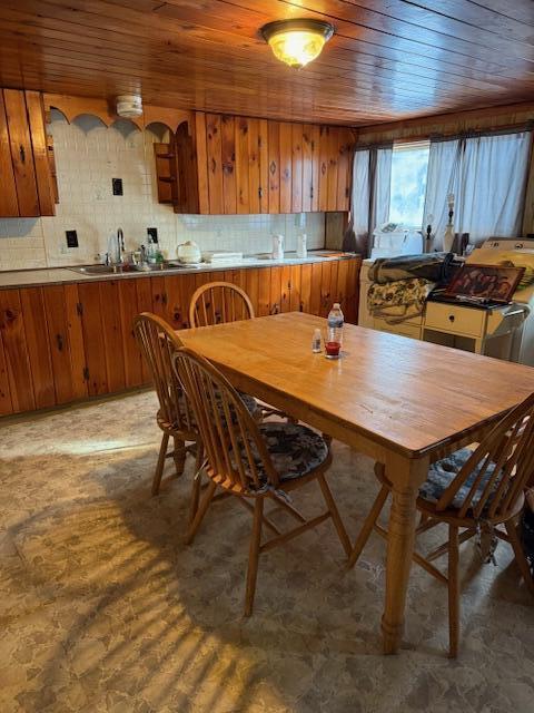 dining room featuring wood ceiling and sink