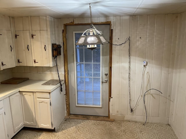 entryway with wooden walls