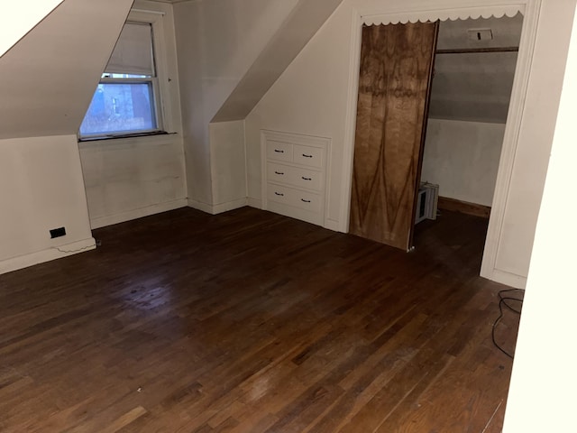 bonus room featuring dark hardwood / wood-style floors and vaulted ceiling