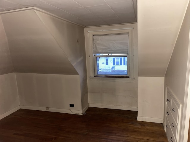 bonus room featuring dark hardwood / wood-style floors and vaulted ceiling