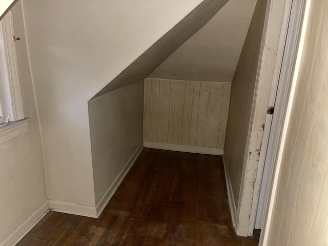 additional living space with dark hardwood / wood-style floors and lofted ceiling