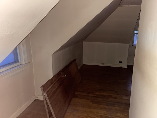 bonus room featuring lofted ceiling and dark wood-type flooring