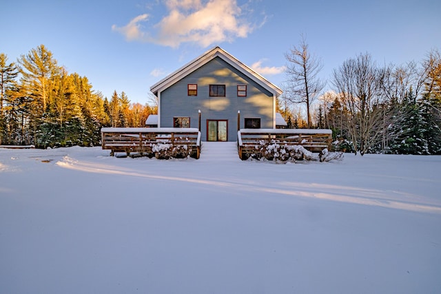 view of snow covered back of property