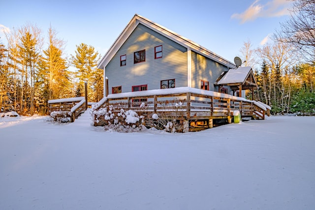 view of snow covered rear of property