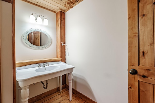 bathroom with hardwood / wood-style floors and wood ceiling