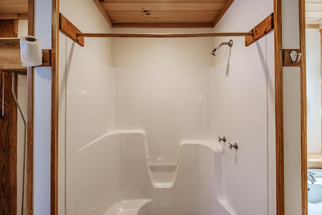 bathroom featuring walk in shower and wooden ceiling