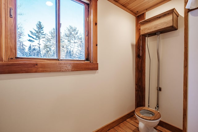 bathroom featuring hardwood / wood-style flooring, toilet, and wooden ceiling