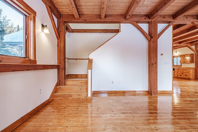 interior space featuring beamed ceiling, wooden ceiling, and light hardwood / wood-style flooring