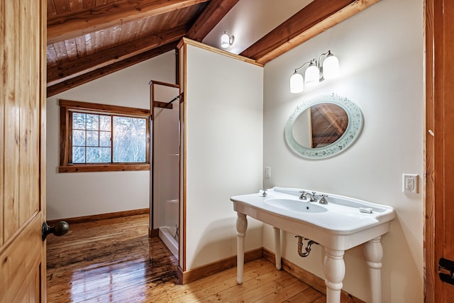 bathroom featuring vaulted ceiling with beams, wood-type flooring, walk in shower, and wooden ceiling