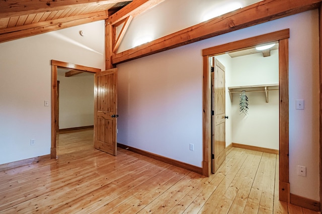 unfurnished bedroom with vaulted ceiling with beams, light wood-type flooring, wood ceiling, and a closet