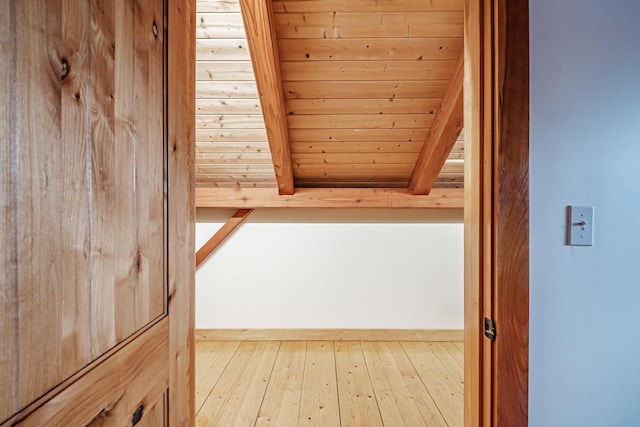 bonus room featuring beam ceiling, wooden ceiling, and light wood-type flooring