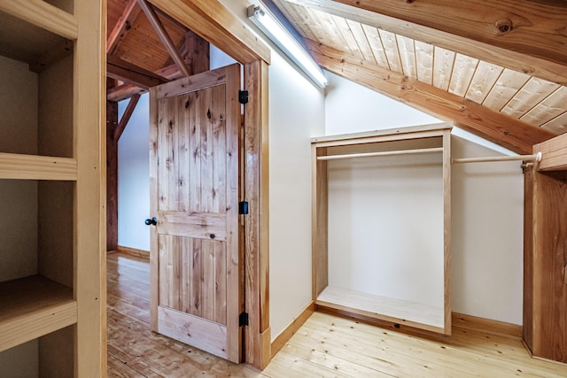 interior space featuring light wood-type flooring, wood ceiling, and vaulted ceiling