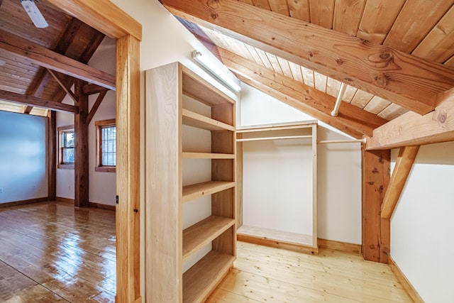 walk in closet with wood-type flooring and lofted ceiling with beams