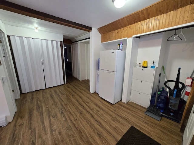 kitchen with beam ceiling, dark wood-type flooring, and white refrigerator