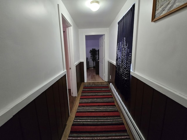 corridor featuring wood walls and dark wood-type flooring