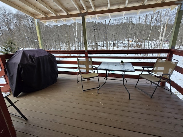 snow covered deck featuring area for grilling