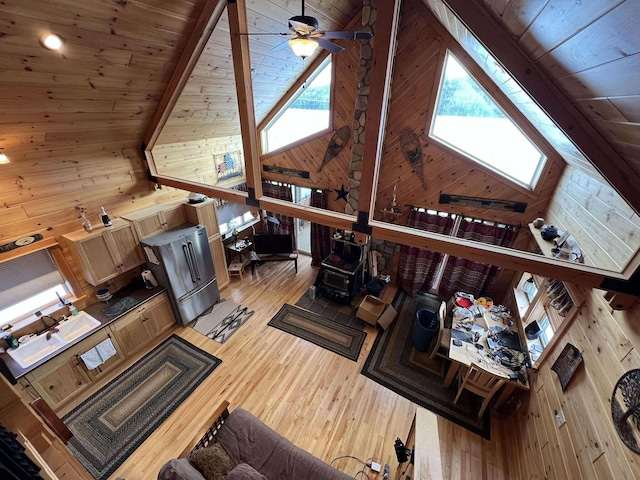 living room featuring wooden ceiling, high vaulted ceiling, wooden walls, and light hardwood / wood-style flooring