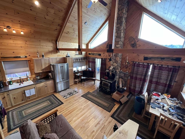 living room featuring a wealth of natural light, sink, and high vaulted ceiling