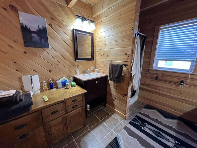 bathroom featuring vanity, walk in shower, and wooden walls