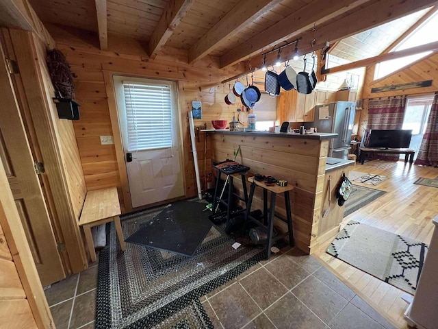 interior space with hardwood / wood-style floors, beam ceiling, wooden ceiling, and wooden walls