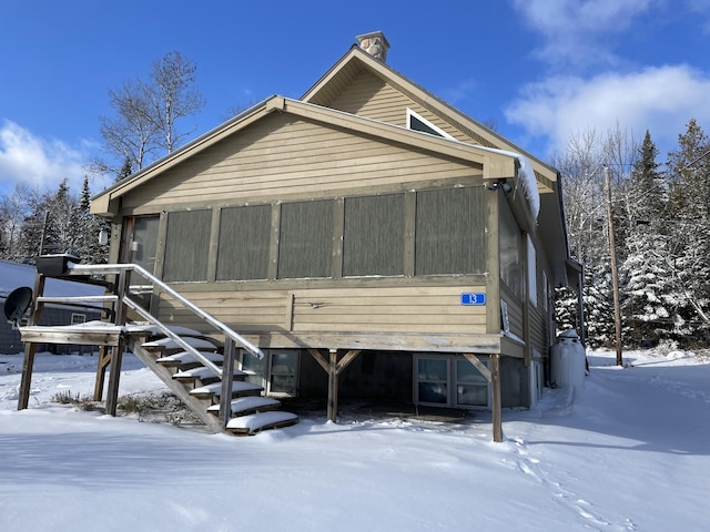 view of snow covered rear of property