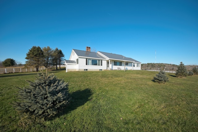19 Branch Brook Rd, Thomaston, ME 04861 - back of house featuring a lawn, a metal roof, and a chimney