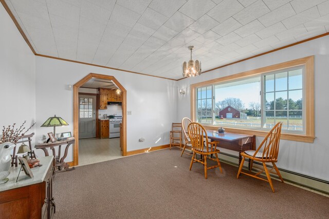 19 Branch Brook Rd, Thomaston, ME 04861 - dining area with ornamental molding, arched walkways, carpet, a chandelier, and a baseboard heating unit