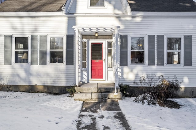 view of snow covered property entrance