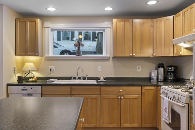 kitchen featuring light brown cabinetry, white appliances, sink, and exhaust hood