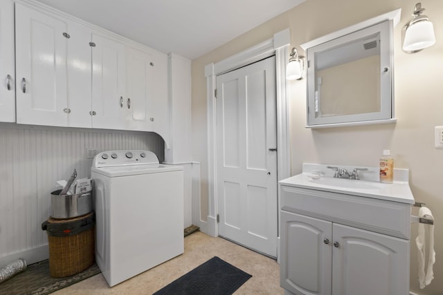 washroom featuring cabinets, washer / dryer, and sink