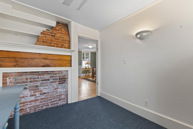 unfurnished living room featuring hardwood / wood-style floors and crown molding