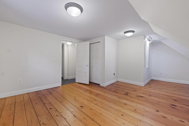 additional living space with light hardwood / wood-style flooring