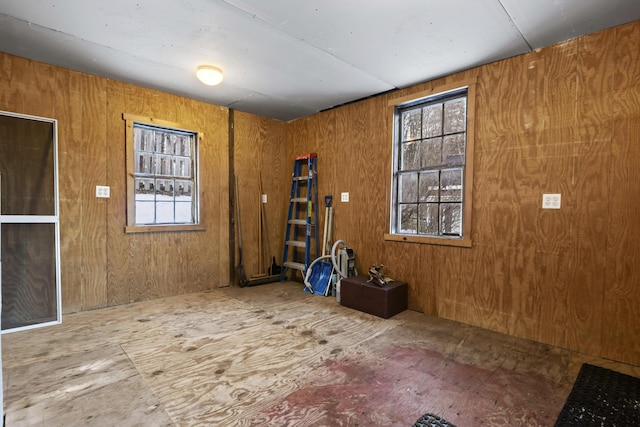 misc room featuring wood walls