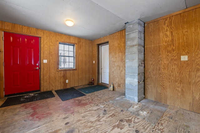 entryway featuring wooden walls