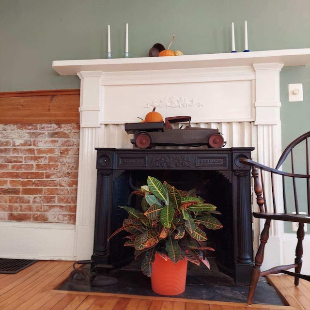 interior details featuring a fireplace and hardwood / wood-style floors