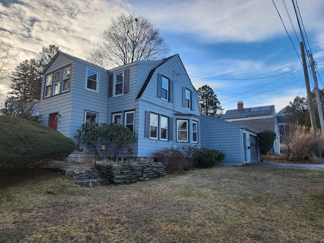 view of side of property with a lawn