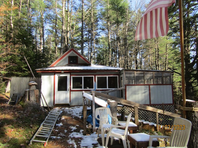 back of property featuring a sunroom