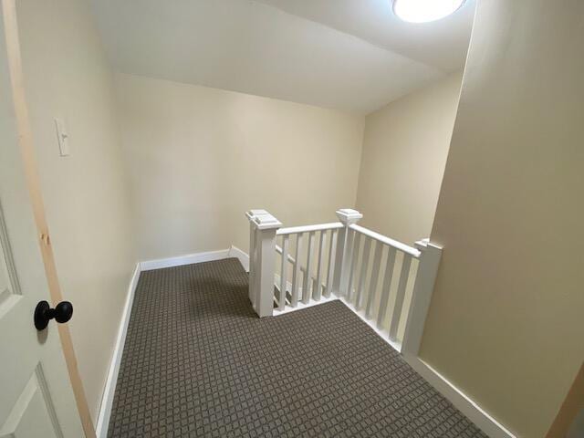 interior space with carpet and baseboards