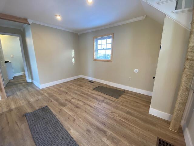 bonus room featuring visible vents, baseboards, and wood finished floors