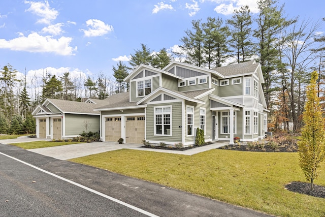 view of front of property featuring a garage and a front lawn