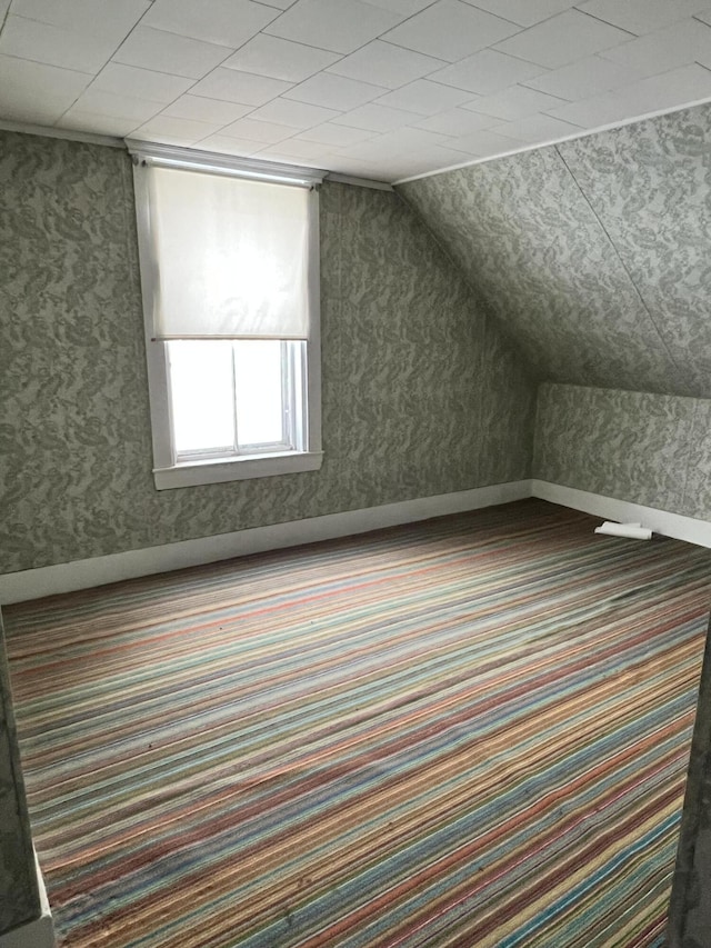 bonus room featuring carpet floors and vaulted ceiling