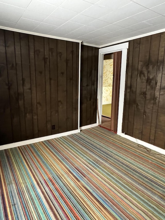 spare room featuring wooden walls