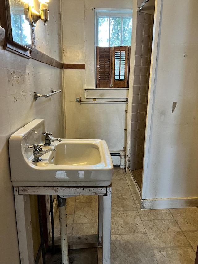 bathroom featuring a shower, tile walls, and a baseboard radiator