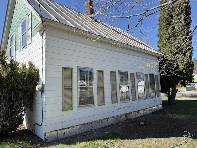 90 Canada Rd, Moscow, ME 04920 - view of home's exterior with a chimney, a metal roof, and a standing seam roof