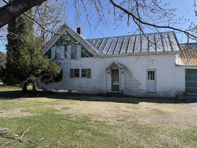90 Canada Rd, Moscow, ME 04920 - view of front facade with a standing seam roof, a metal roof, entry steps, a chimney, and a front lawn