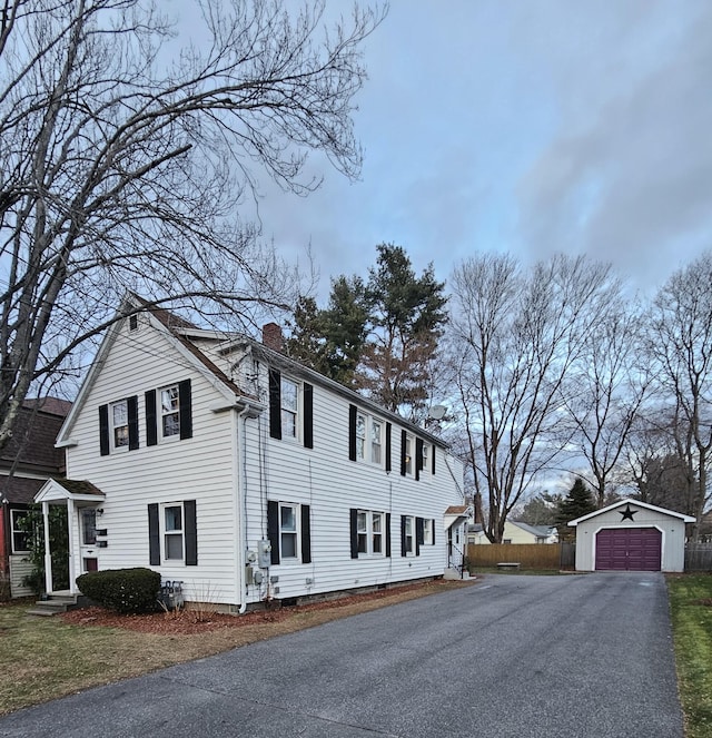 view of side of property featuring an outbuilding and a garage