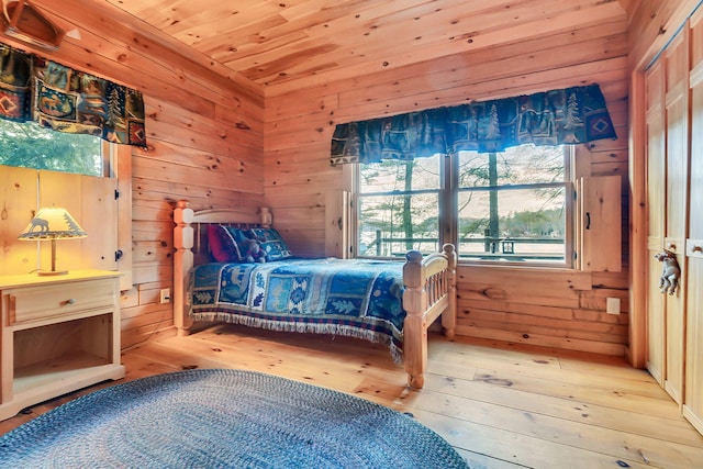 bedroom with wood-type flooring, wooden walls, and wood ceiling